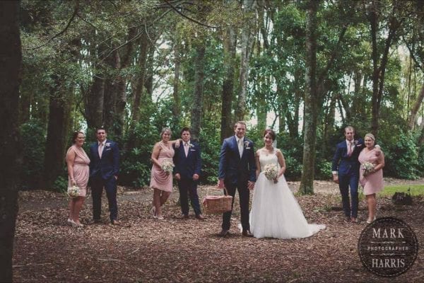 Bridal party in blush pink with navy blue suits
